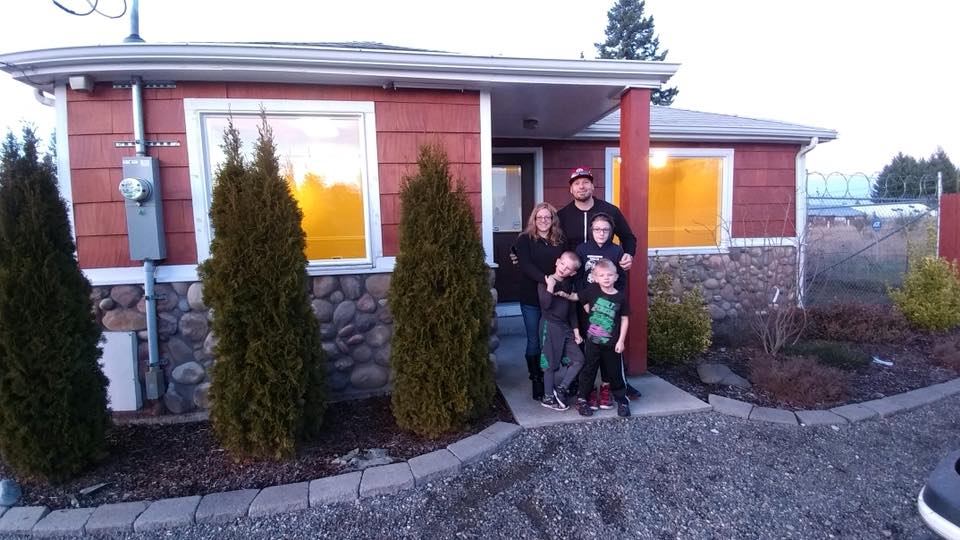 Ben and his family pictured in front of their office. 