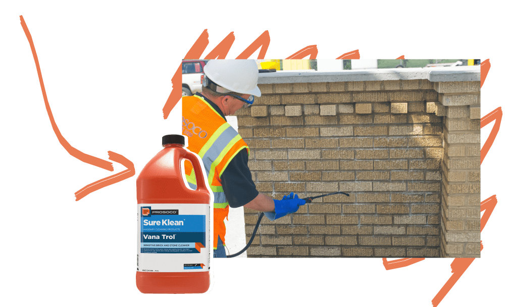 Vana Trol cleaning excess mortar off of buff brick.
