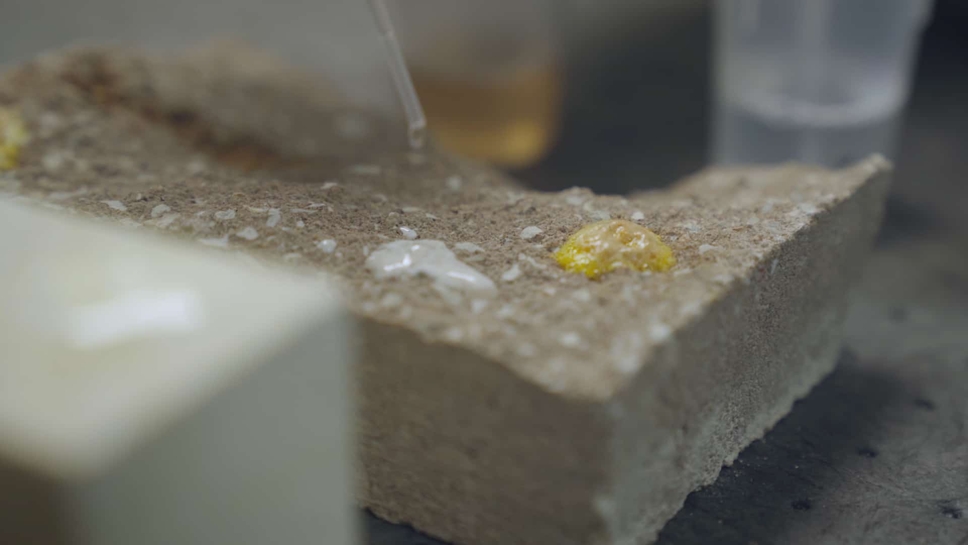 Two acidic masonry cleaners are tested on concrete block.