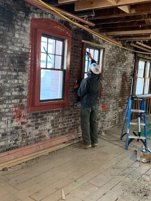 Negative side air barrier installed at a college dorm retrofit.