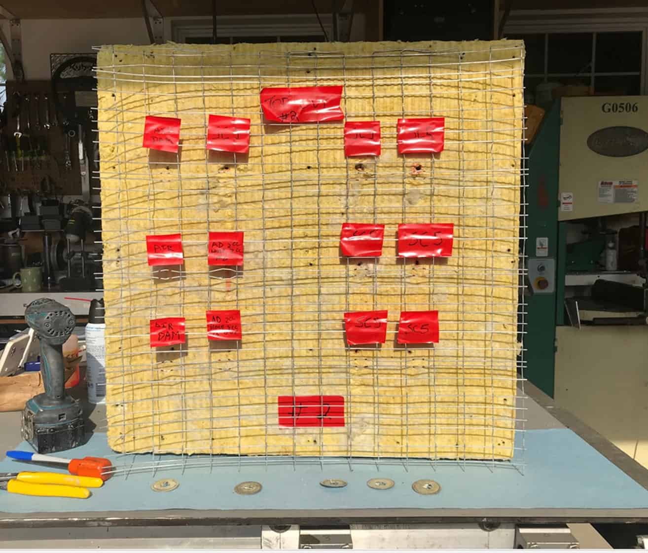 Figure 14.
Lath grid laid over insulation to identify means of sealing material used on both sides of the mockup.
