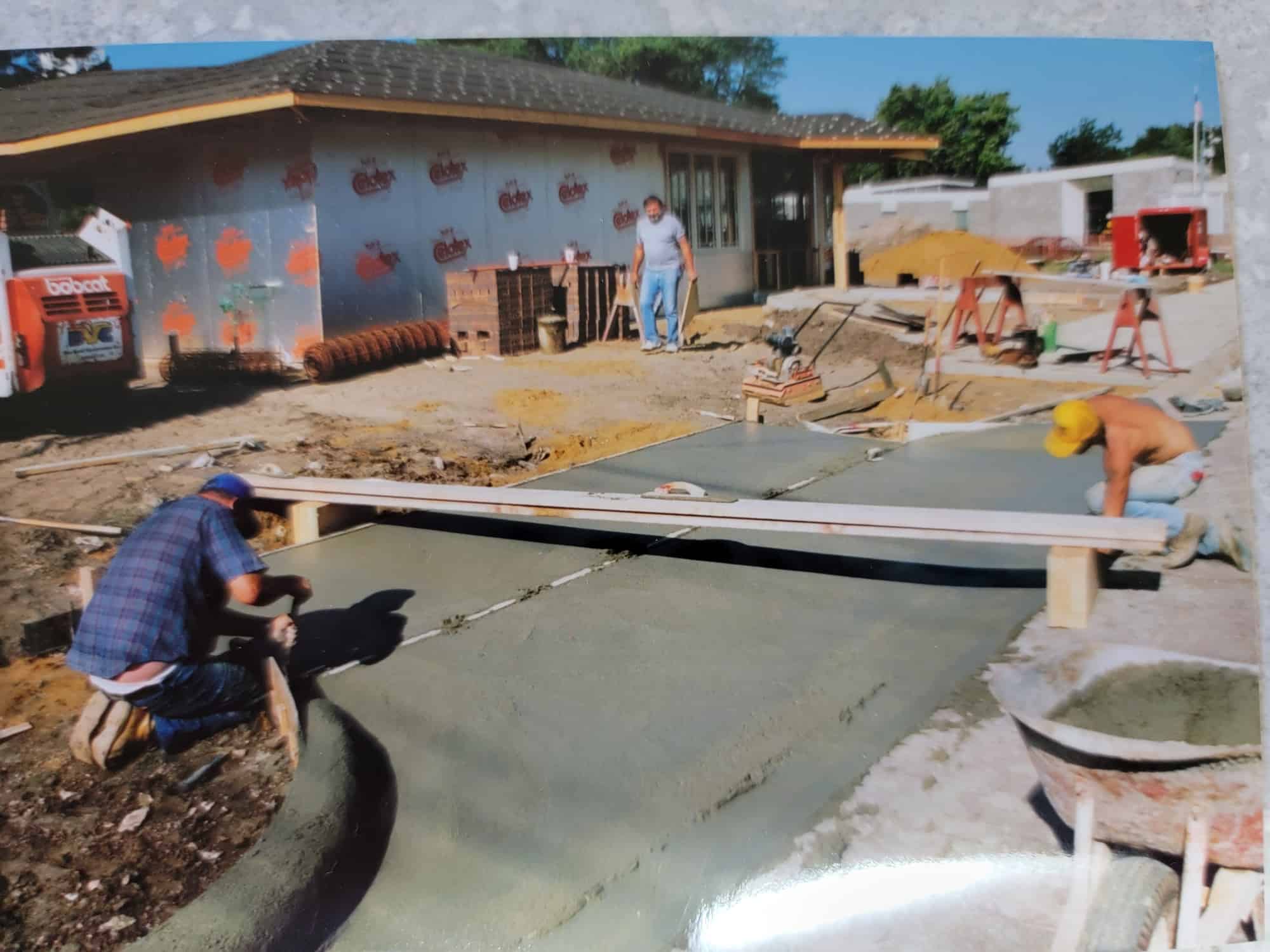 Troy (far right) poured plenty of concrete in his younger days, but today he's making artwork out of it. 