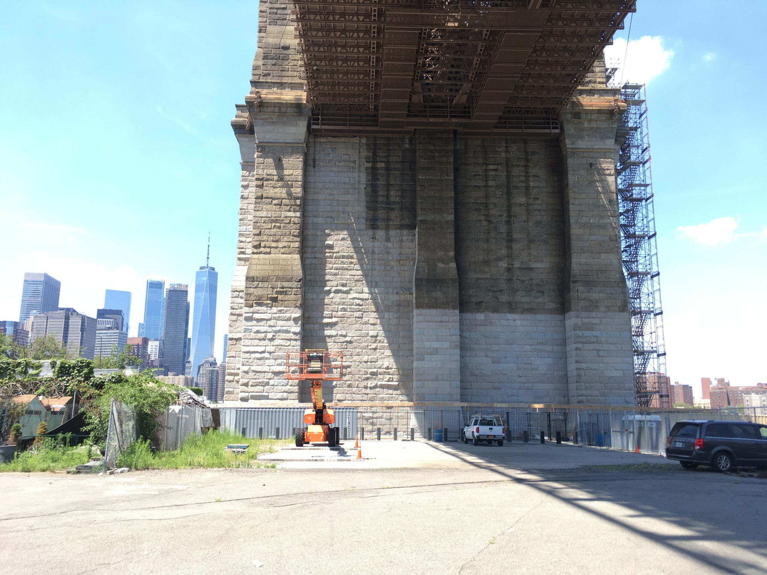 A shot from underneath the bridge shows the contrast of the Brooklyn Tower mid-cleaning.