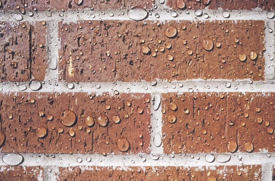 water beads on red brick